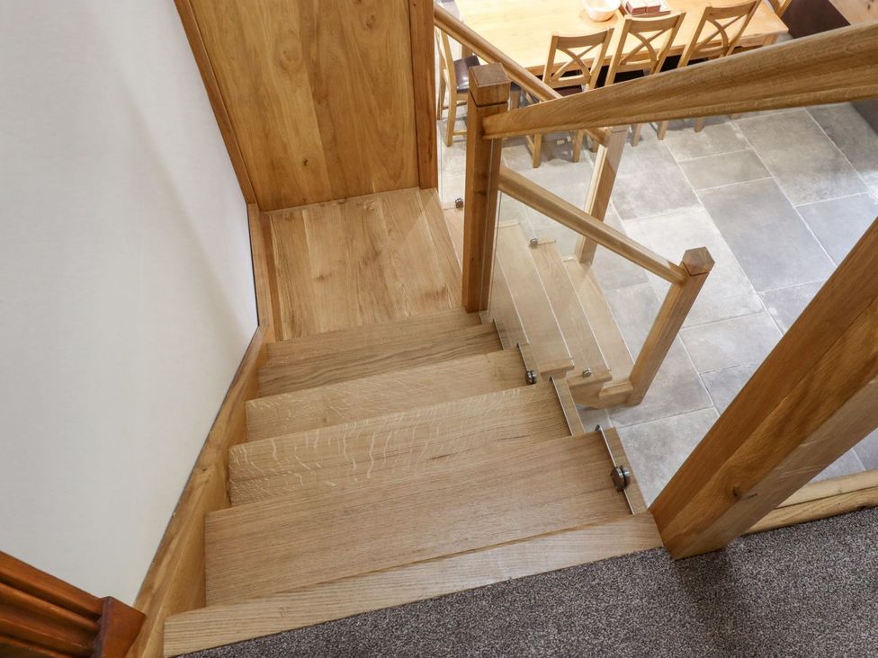 Stairs leading down to a dining area at Orcaber Farmhouse in Lancaster