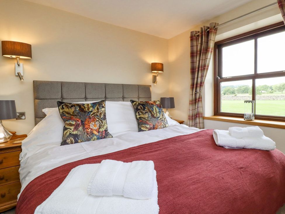 A bedroom with a bed and pillows at Orcaber Farmhouse in Lancaster