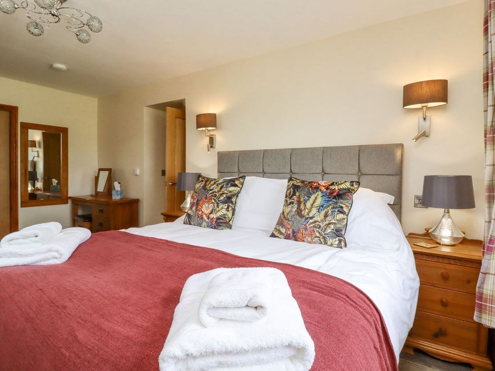 A bedroom with bed and bedside tables at Orcaber Farmhouse Lancaster