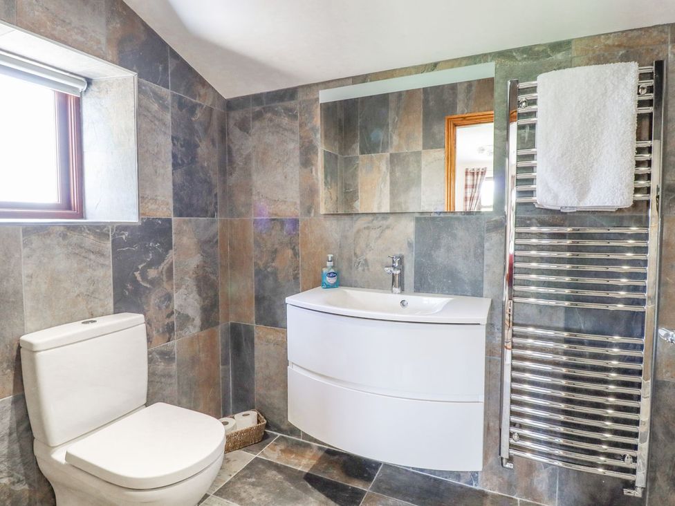 A bathroom with a sink and toilet at Orcaber Farmhouse in Lancaster