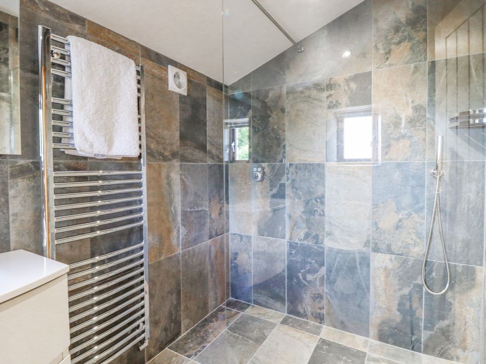 A bathroom with a shower and towel rack at Orcaber Farmhouse in Lancaster