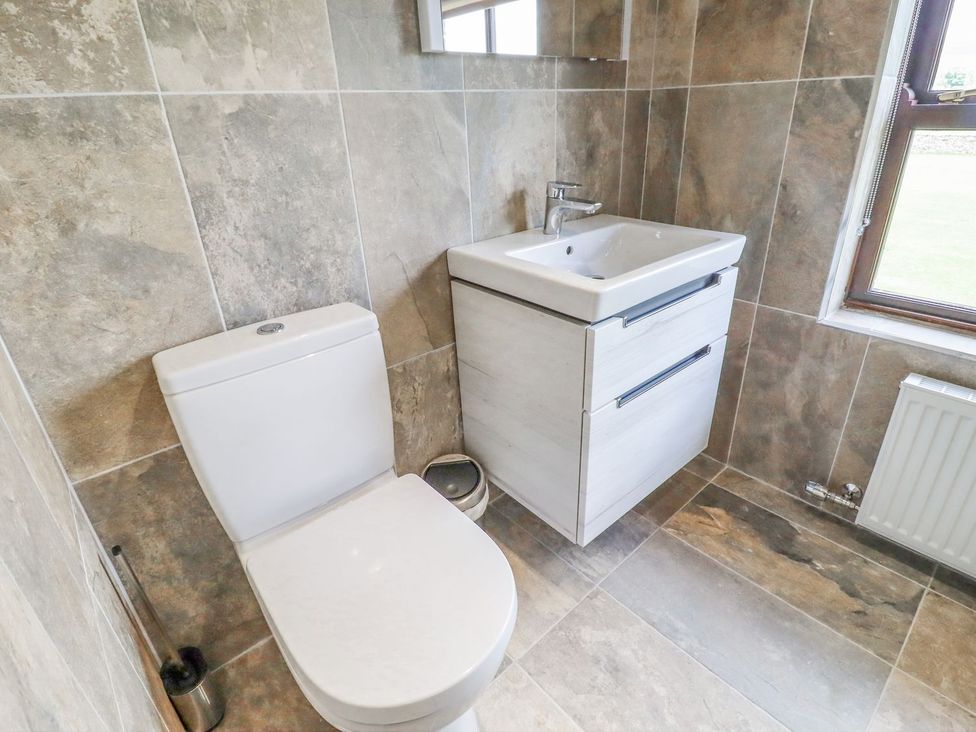 A bathroom with a sink and toilet at Orcaber Farmhouse in Lancaster