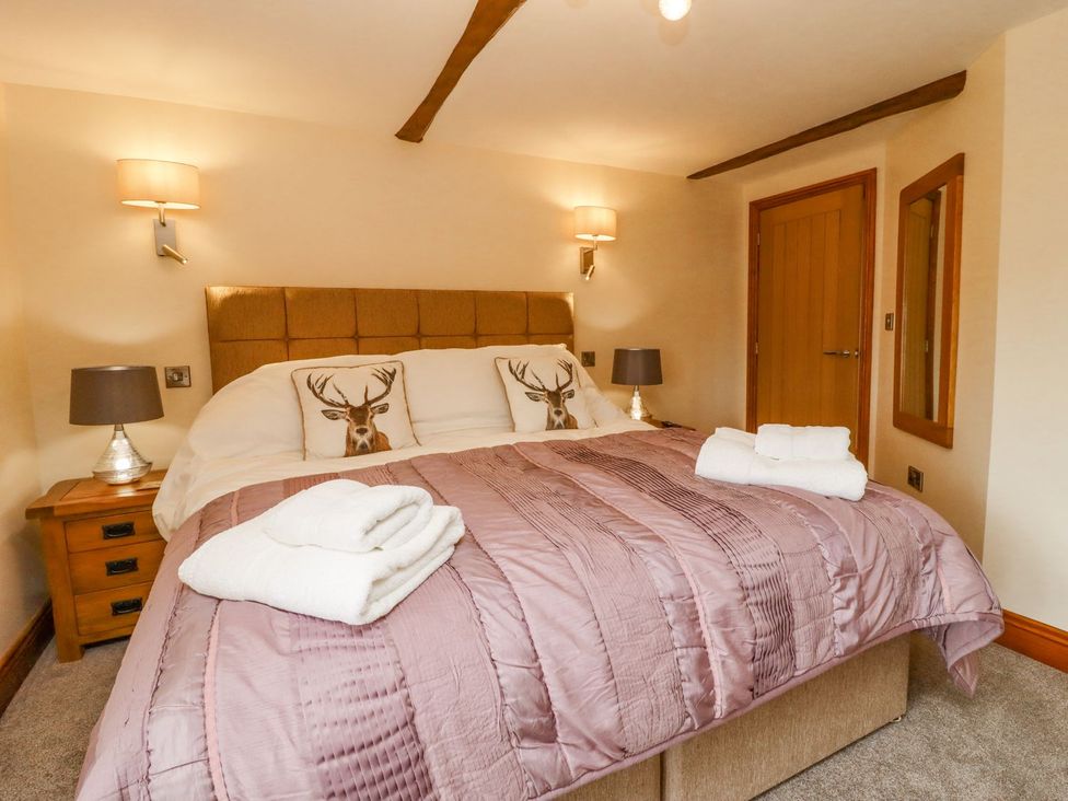 A bedroom with a double bed and side tables at Orcaber Farmhouse in Lancaster