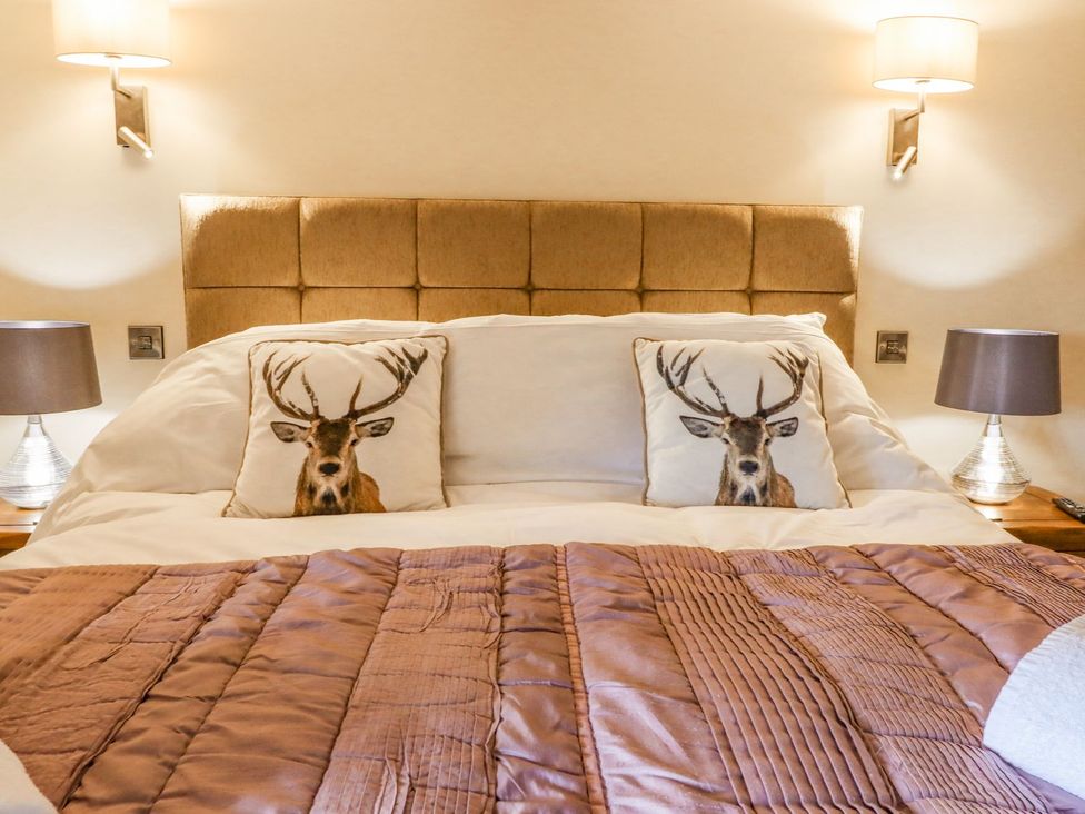 A bedroom with a bed and decorative pillows at Orcaber Farmhouse in Lancaster