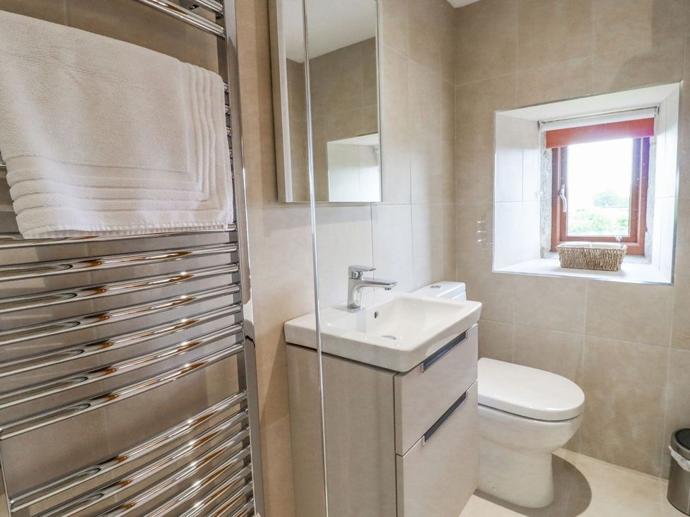 A bathroom with a sink and towel radiator at Orcaber Farmhouse Lancaster