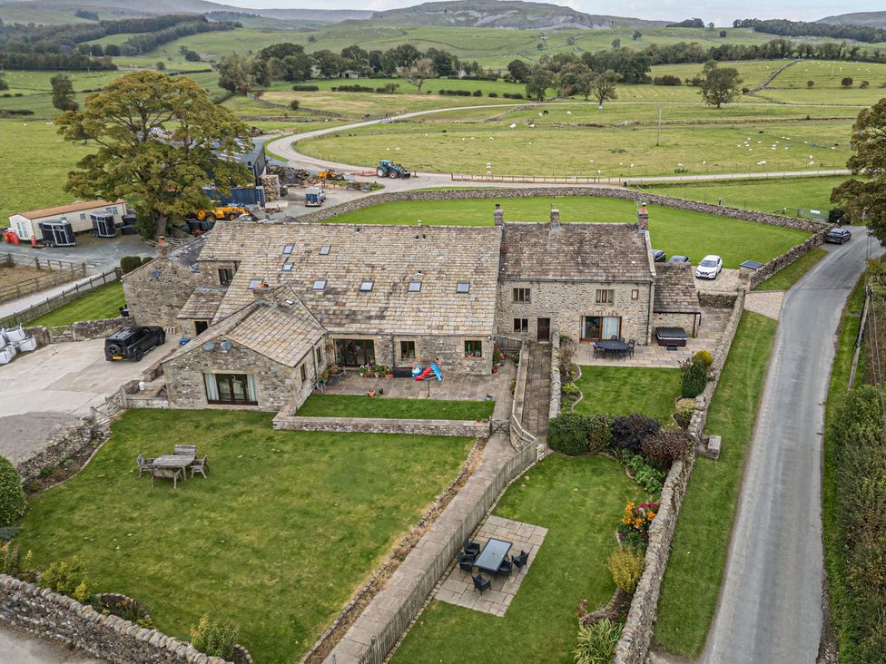 An outdoor view of a house and garden at Orcaber Farmhouse in Lancaster