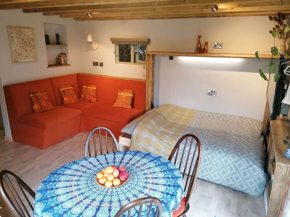 A living room with a sofa and a dining table at Stone Moor Lodge, Justin's Peak District Base Camp in Sheffield
