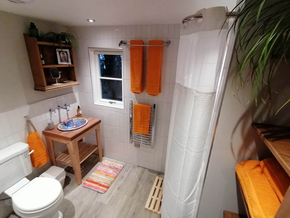 A bathroom with a sink and towel rack at Stone Moor Lodge, Justin's Peak District Base Camp, Sheffield