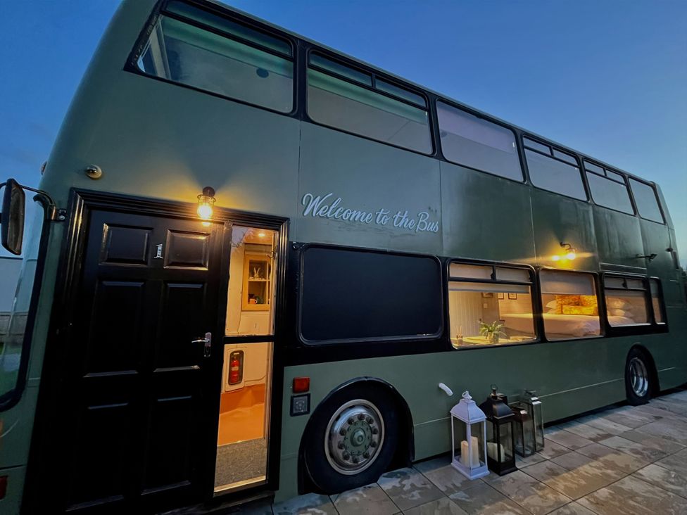 An outdoor view of a bus with a welcome sign at No 1 The Depot in Gateshead