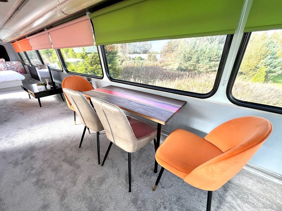 A dining area with a table and chairs at No 1 The Depot in Gateshead