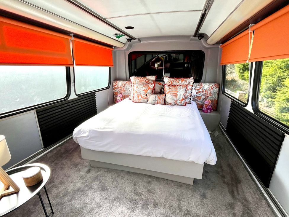 A bedroom with a bed and decorative pillows at No 1 The Depot in Gateshead