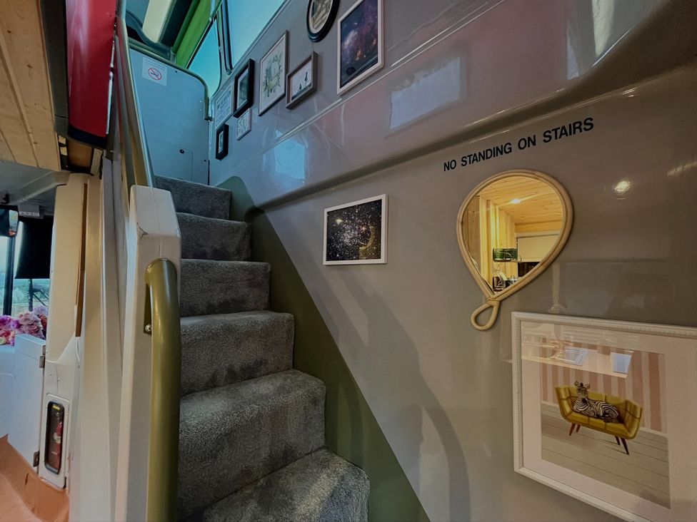 A staircase with wall art and a mirror at No 1 The Depot in Gateshead