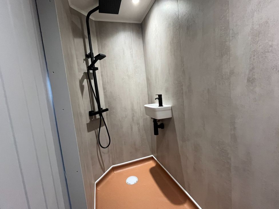 A shower with a sink in a bathroom at No 1 The Depot in Gateshead