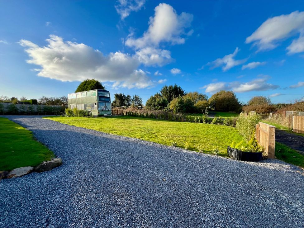 A double-decker bus and gravel driveway in a field at No 1 The Depot in Gateshead
