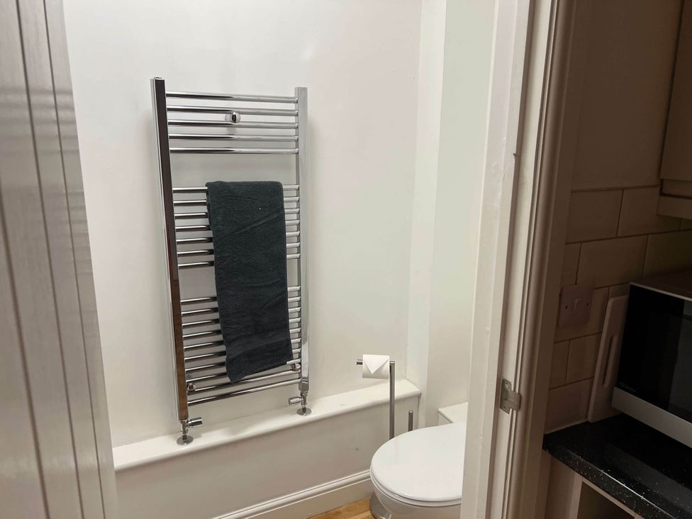 A bathroom with a towel rail and toilet at Seaside Cottage Escape in Paignton