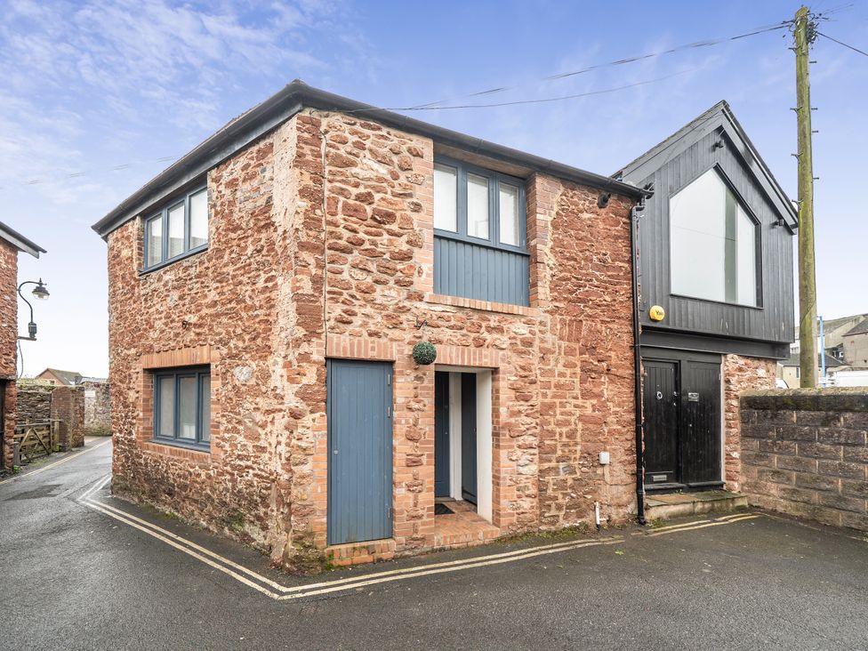 A brick building with windows and doors at Seaside Cottage Escape in Paignton