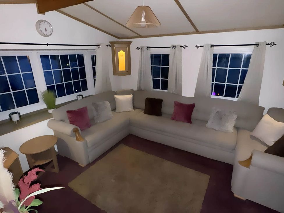 A living room with a sofa and coffee table at Llanarmon-yn-Ial Mold 3-Bed Caravan, Sleeps 6 Llanarmon-Yn-Ial