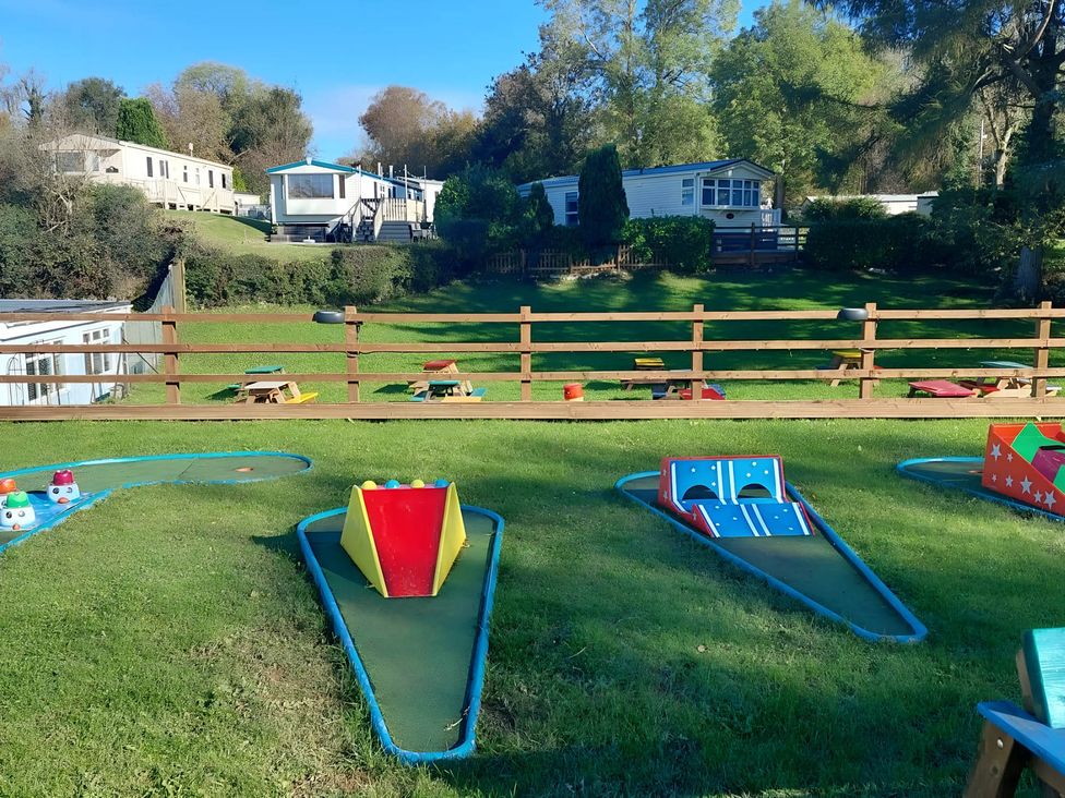 An outdoor mini golf course with caravans in the background at Llanarmon-yn-Ial Mold 3-Bed Caravan, Sleeps 6 in Llanarmon-Yn-Ial