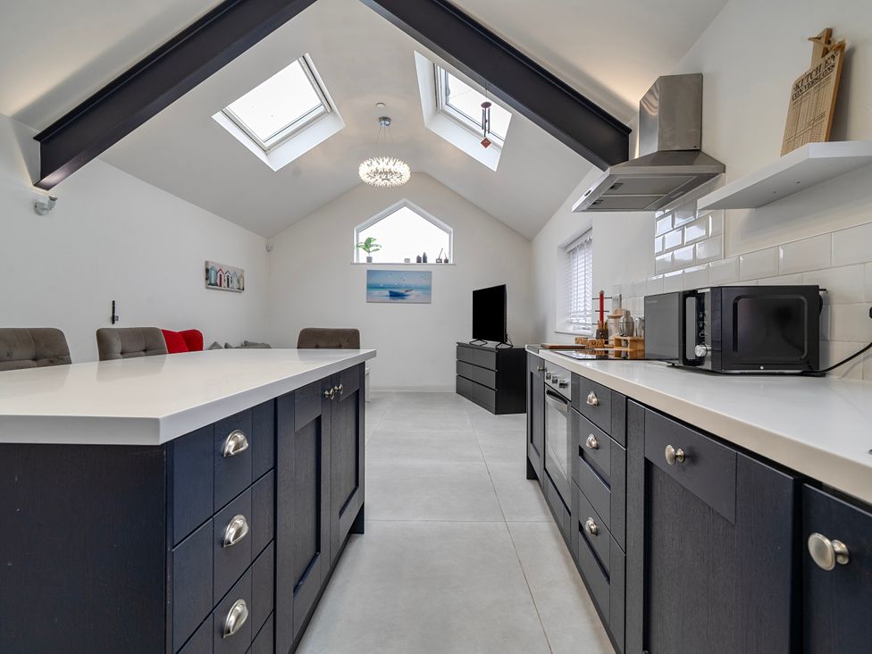 A kitchen with an island and appliances at Modern Seaside Cottage - Sleeps 5 in Paignton