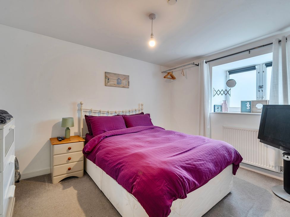 A bedroom with a bed and bedside table at Modern Seaside Cottage - Sleeps 5 in Paignton