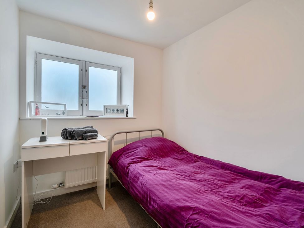 A bedroom with a bed and desk at Modern Seaside Cottage - Sleeps 5 in Paignton