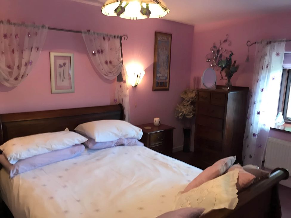 A bedroom with a bed and dresser at Converted Stone Barn -20 Acres - Farm Animals! Corwen