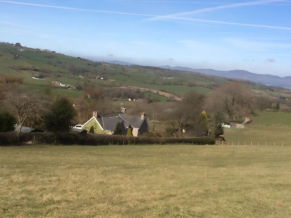 A landscape view with houses and fields at Converted Stone Barn -20 Acres - Farm Animals! in Corwen