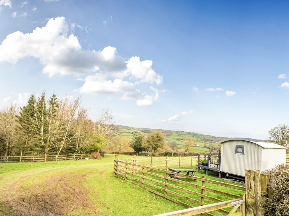 An outdoor area with a shed and fencing at Converted Stone Barn -20 Acres - Farm Animals! in Corwen
