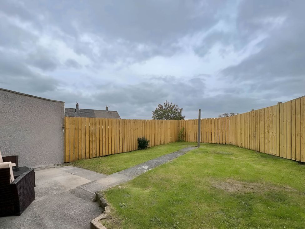 A garden with grass and a pathway at 2 Bed House - Sleeps 4 - Garden - Parking - Wifi, Kendal