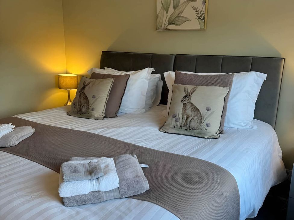 A bedroom with a bed and pillows at 2 Bed House - Sleeps 4 - Garden - Parking - Wifi in Kendal
