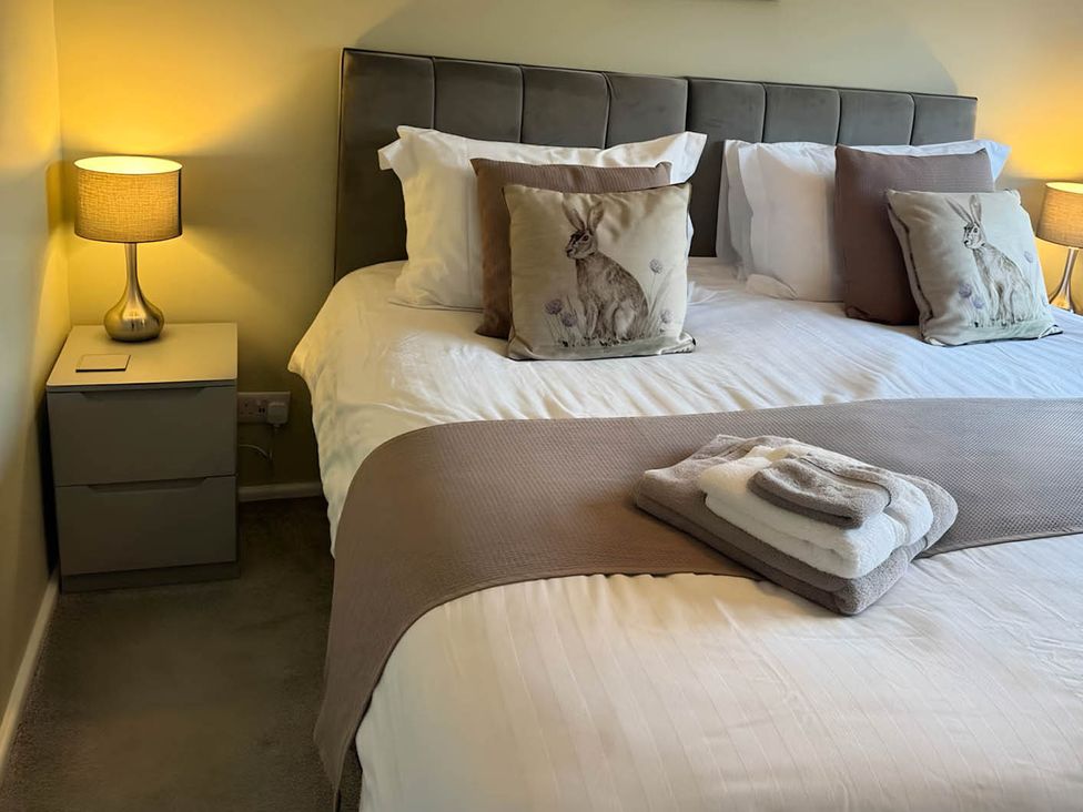 A bedroom with a bed and bedside lamp at 2 Bed House - Sleeps 4 - Garden - Parking - Wifi, Kendal