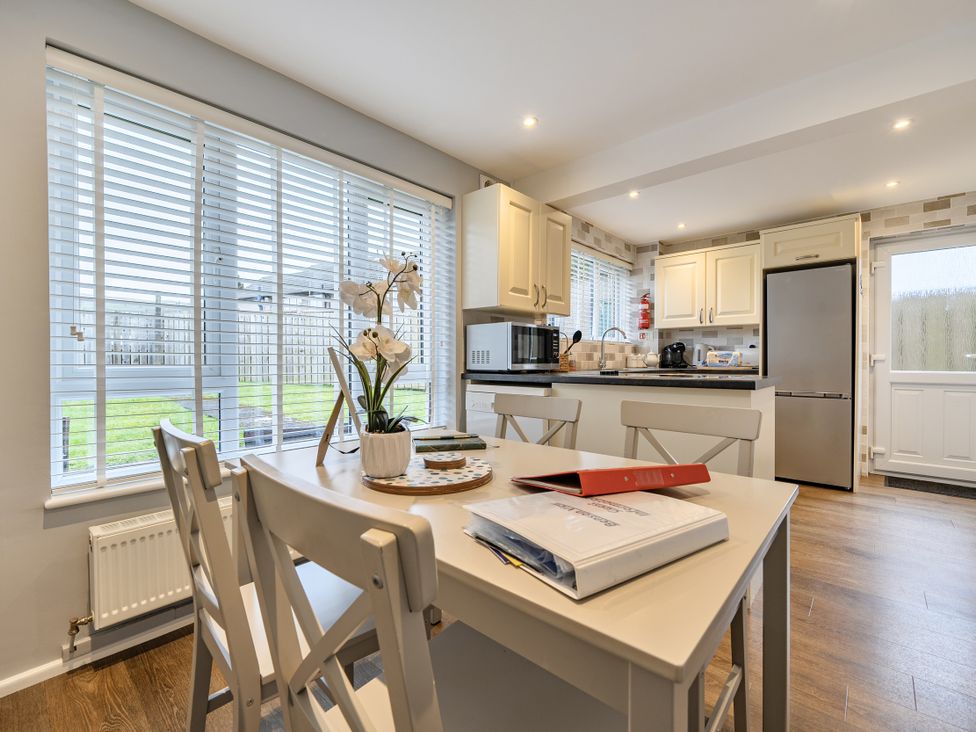 A kitchen with a table and chairs at 2 Bed House - Sleeps 4 - Garden - Parking - Wifi in Kendal