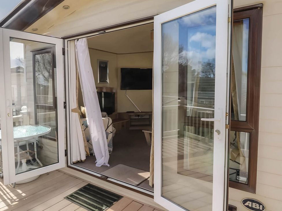 A living room with a sofa and television at CaravanSleeps6-FreeParking-QuietRetreat-Nature in Paignton