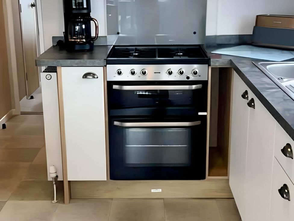 A kitchen with an oven and coffee maker at 293 Static caravan Beverley Bay Paignton