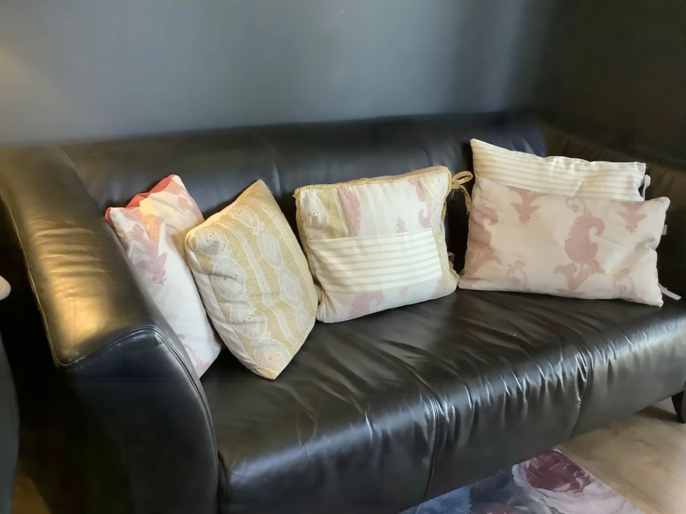 A sofa with cushions at Dobbin the horse box in The Lake District