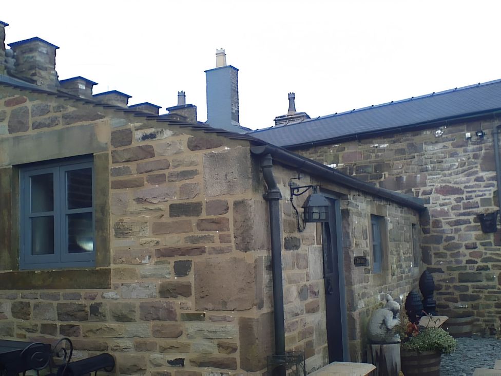 An exterior view of a stone cottage with a window and door at 1 Bed Cottage - Sleeps 3 - Garden - Parking - Wifi Buxton