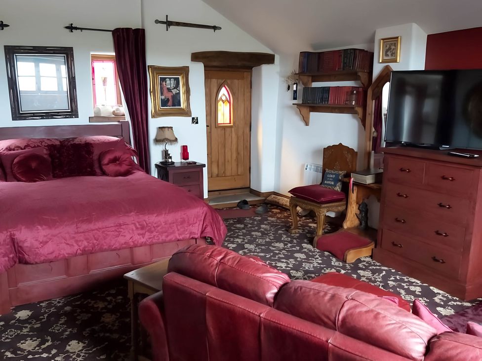 A bedroom with a bed, television and bookshelf at 1 Bed Cottage - Sleeps 3 - Garden - Parking - Wifi in Buxton