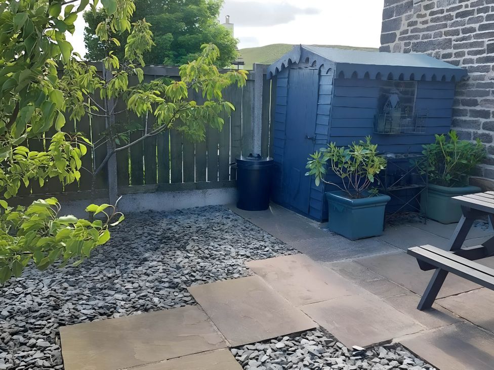 A garden with a shed, gravel area, paving stones, and planters at 1 Bed Cottage - Sleeps 3 - Garden - Parking - Wifi, Buxton