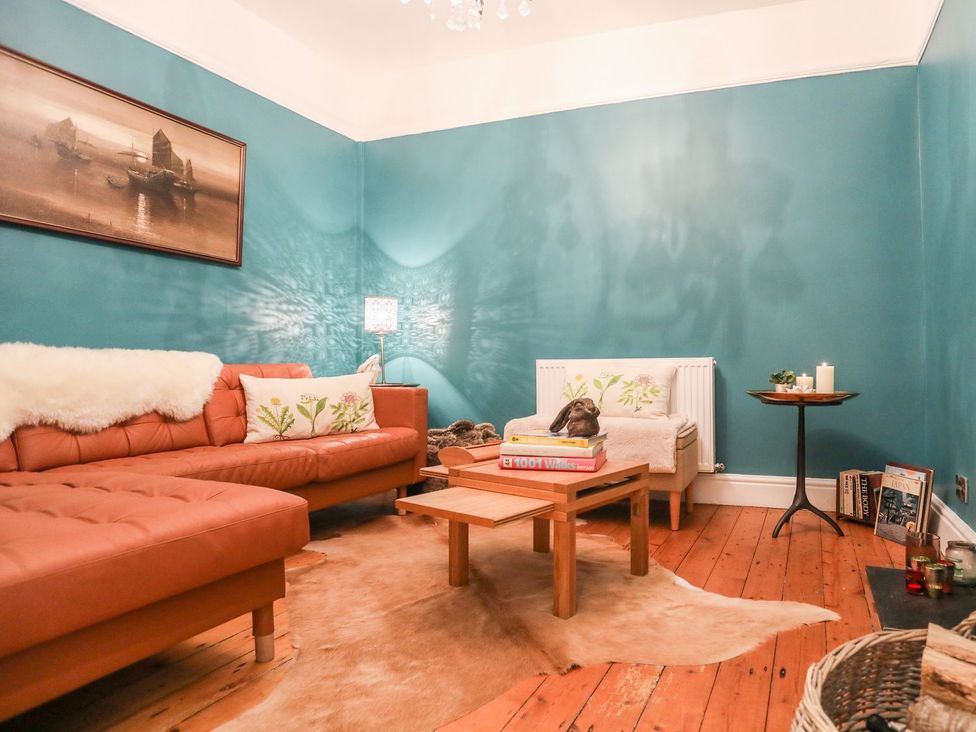 A living room with a sofa and coffee table at Rhiwlas in Rhosneigr