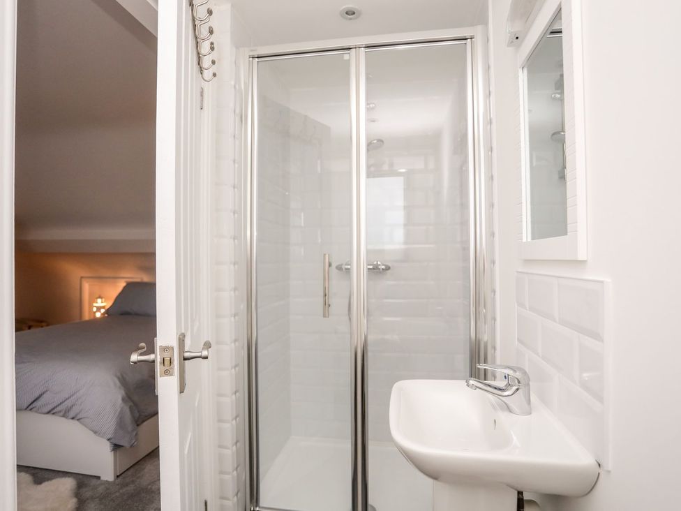 A bathroom with a shower and sink at Rhiwlas, Rhosneigr