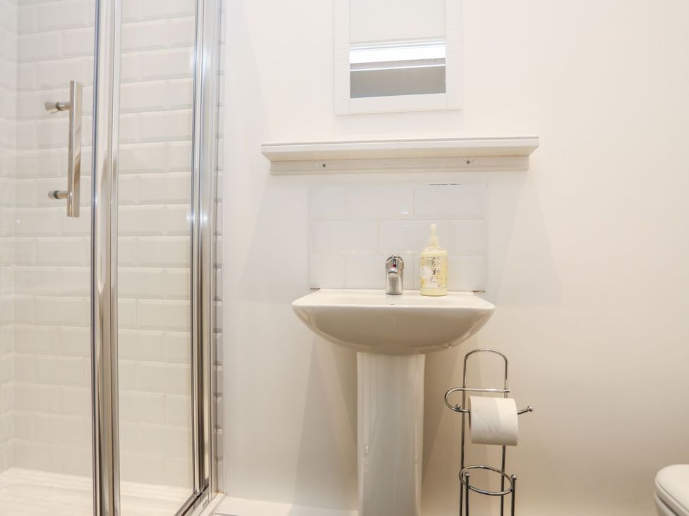 A bathroom with a shower and sink at Rhiwlas in Rhosneigr