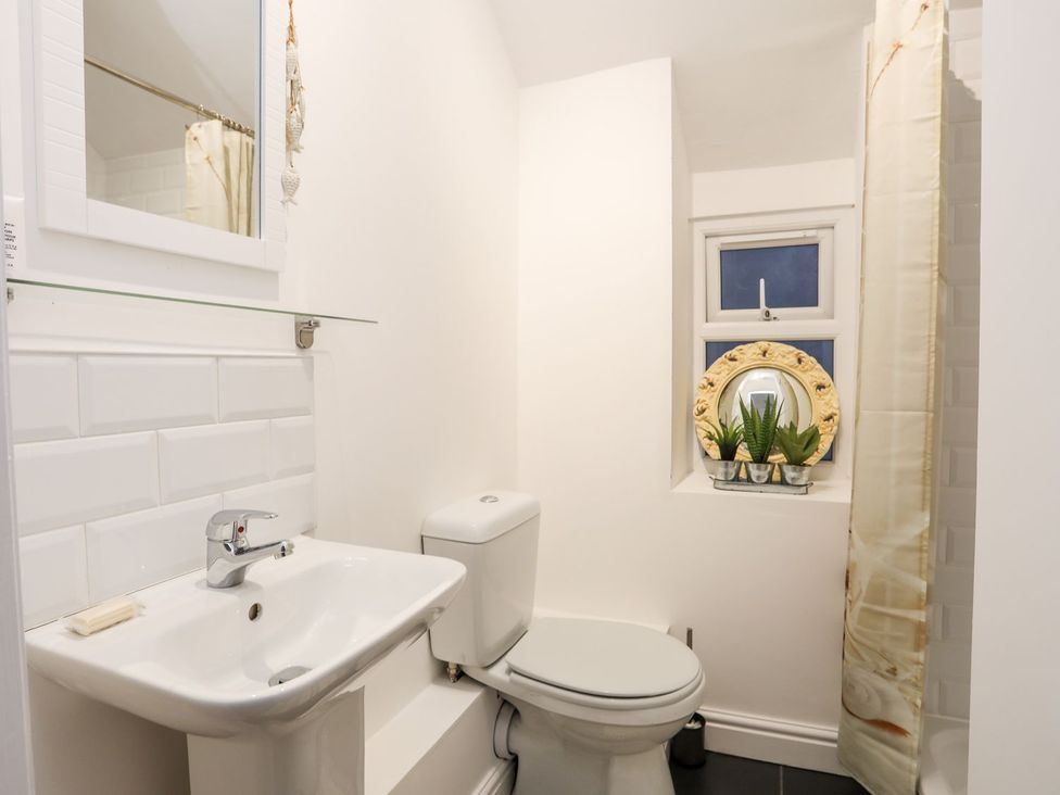 A bathroom with a sink and toilet at Rhiwlas in Rhosneigr