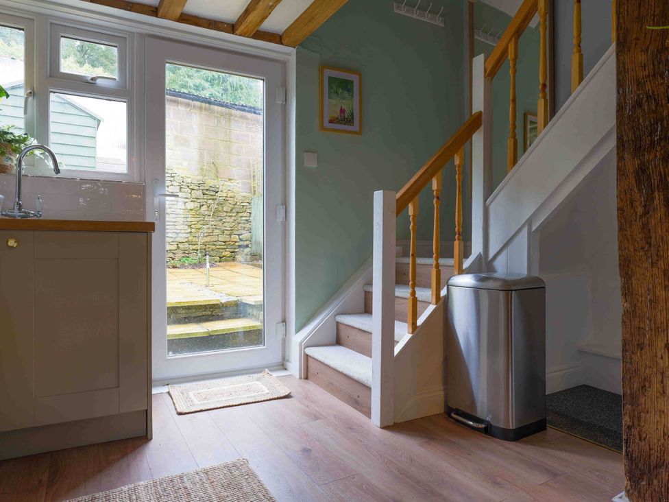 A kitchen sink and stairs in the entrance of Cotswolds Cozy Cottage Retreat - pet friendly, Finstock