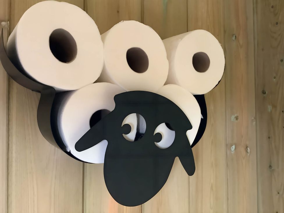 A sheep design wall holder with toilet paper at The Shepherds Hut at Hafoty Boeth in Corwen