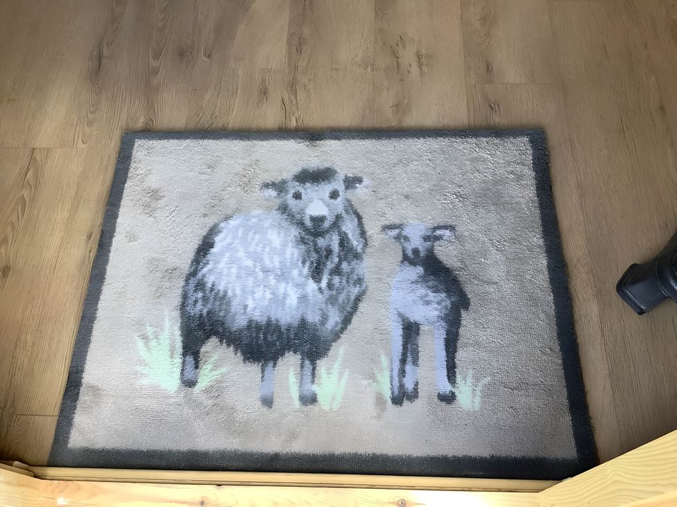 A rug with a sheep and a lamb design at The Shepherds Hut at Hafoty Boeth, Corwen