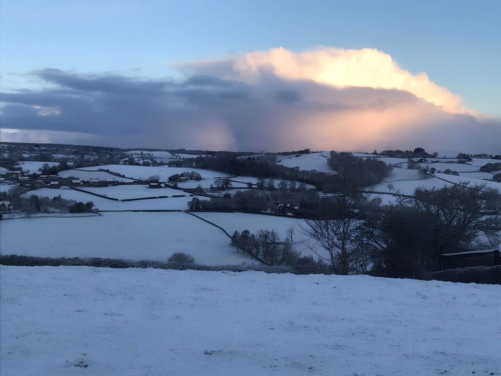 A snowy landscape with fields and trees at The Shepherds Hut at Hafoty Boeth Corwen