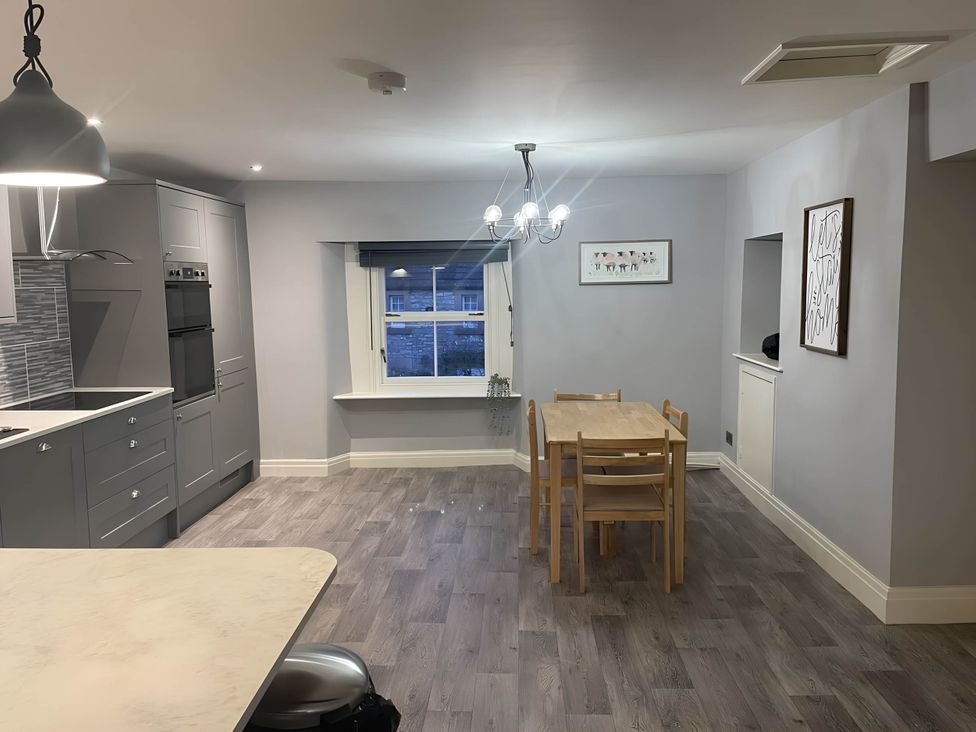 A kitchen with dining table and chairs at Cosy Apartment above Village Pub