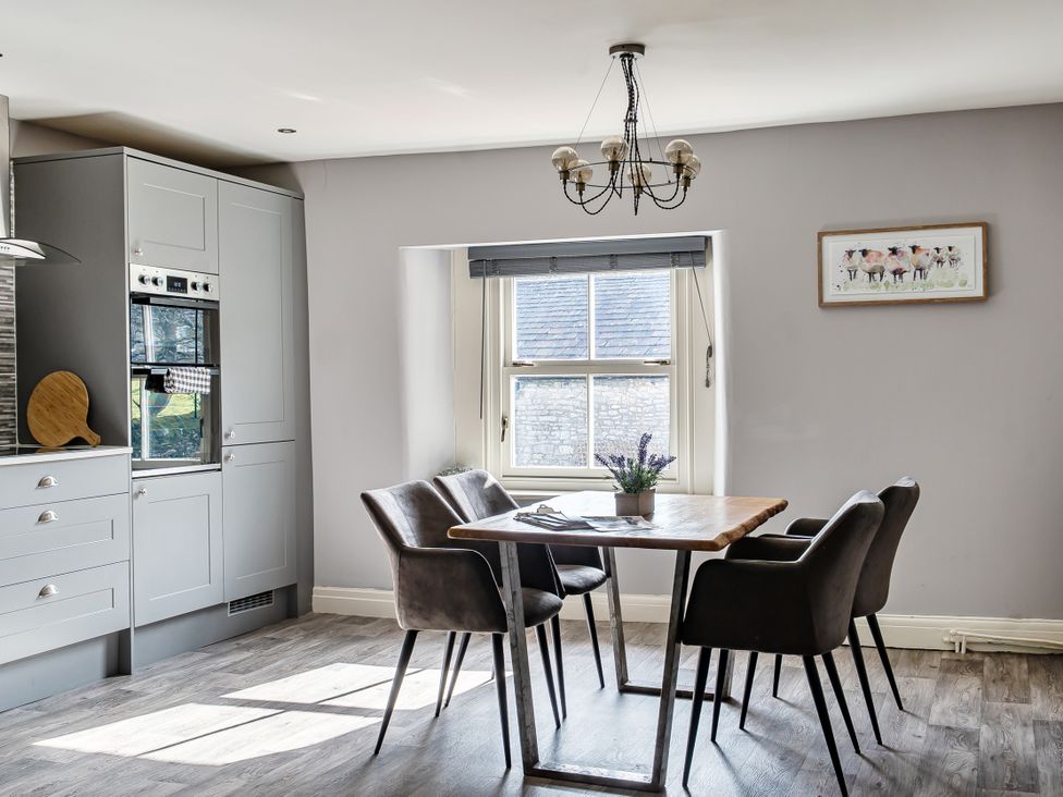 A dining room with a table and chairs at Cosy Apartment above Village Pub in Taddington