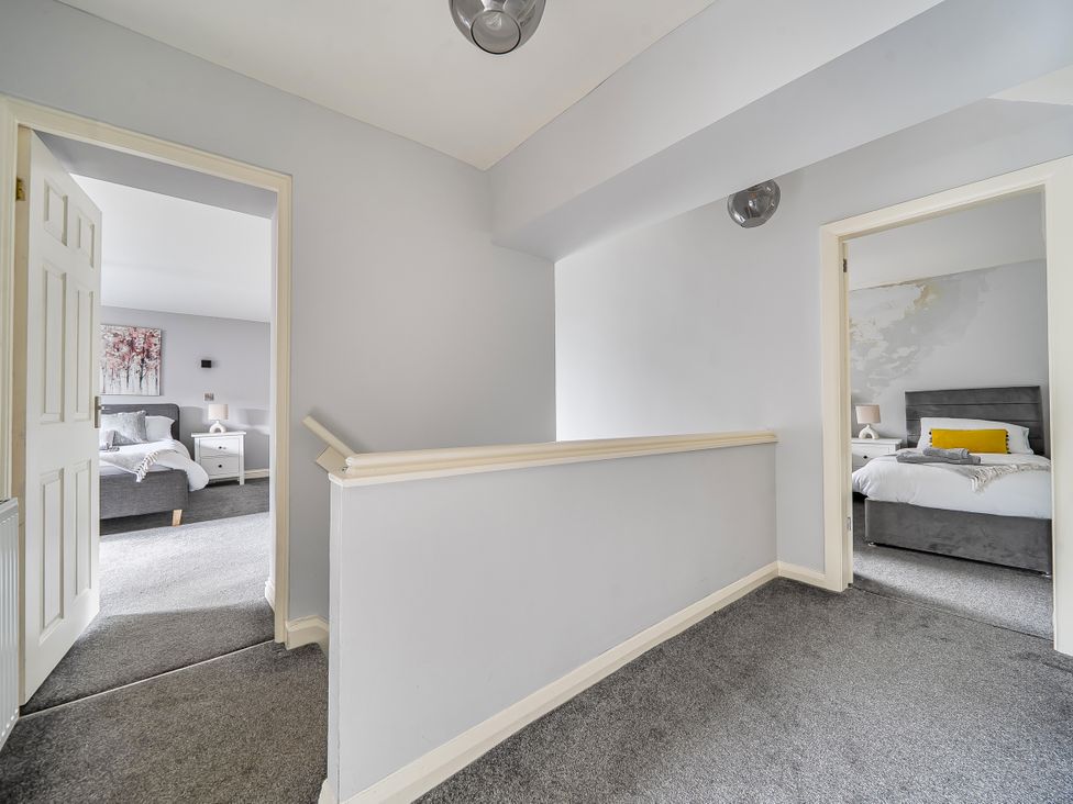 A hallway with doors leading to bedrooms at Cosy Apartment above Village Pub Taddington