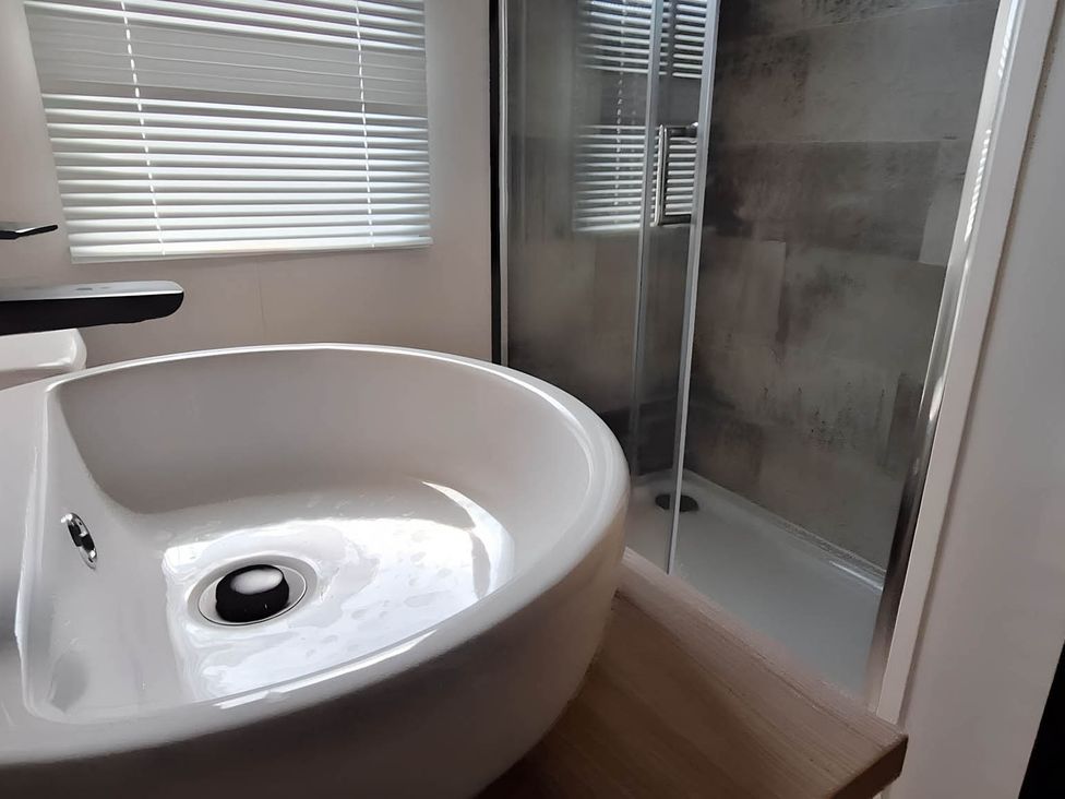 A sink and shower in a bathroom at Tranquil Lodge Retreat in Paignton